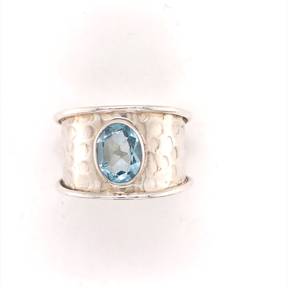 Sterling silver wide hammered ring w/oval blue topaz